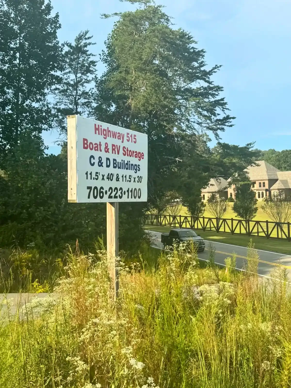 White sign on a hill outside a metal building
